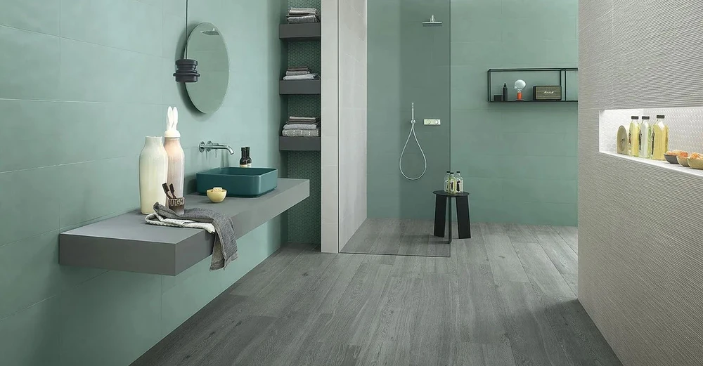 Salle de bain moderne avec douche à l'italienne, vasque rectangulaire sur plan suspendu, miroir rond et étagères murales